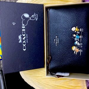 Brand new….still in original box snoopy wristlet.